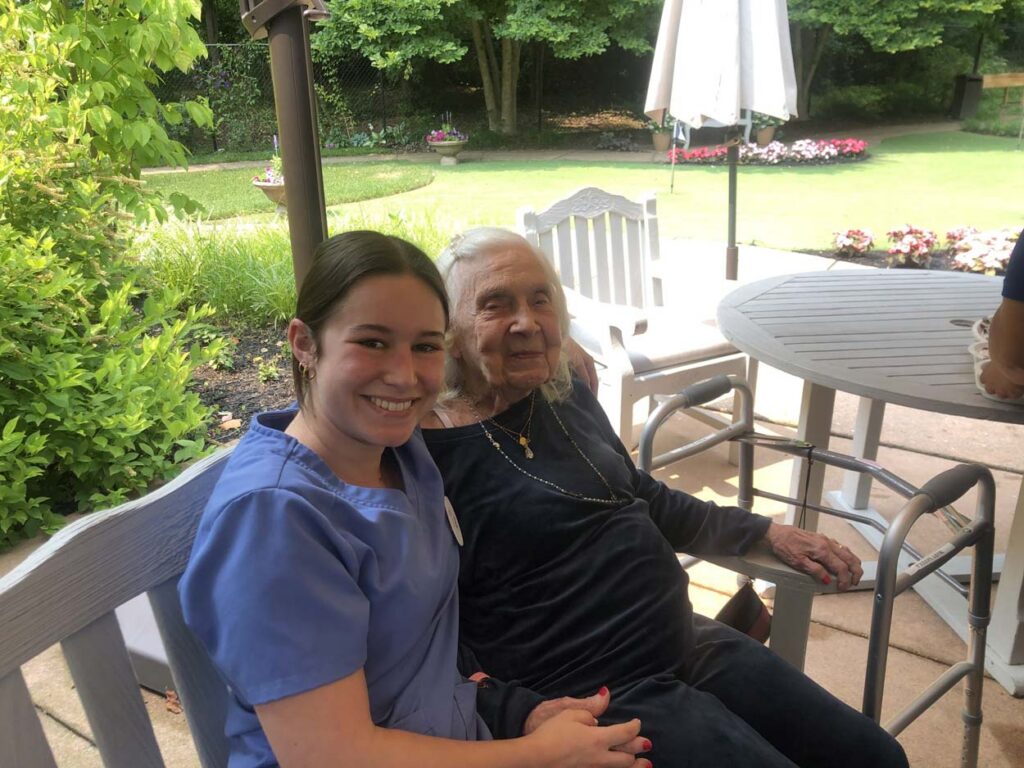 Caregiver comforting resident at Arbor Place, compassionate dementia care in Rockville, MD | Memory Care Facility in Rockville, MD