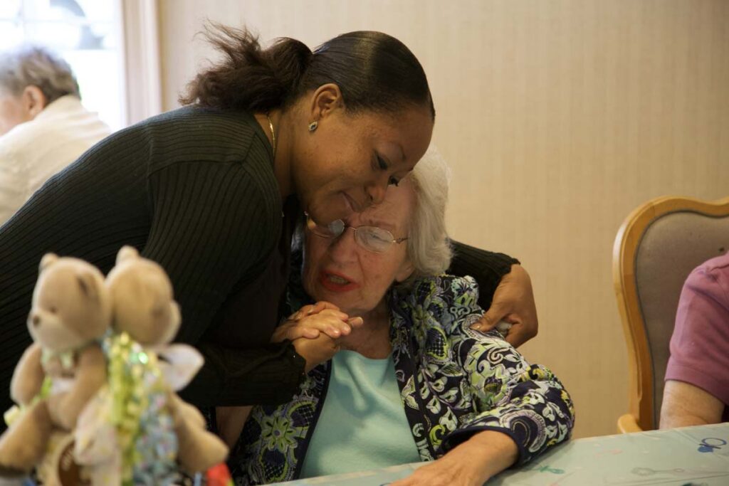 Caregiver and resident in the garden at Arbor Place dementia care community, Rockville, MD | Dementia Specialist Rockville MD
